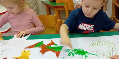 Powiększ grafikę: Dziewczynka i chłopiec z grupy I kolorują dinozaury