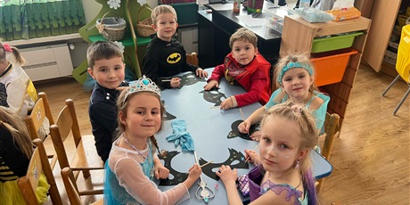 Powiększ grafikę: Dzieci z grupy III w strojach karnawałowych - dzieci wykonują przy stolikach maski karnawałowe